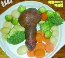 A vegetable dish with chicken meat made to resemble a penis.